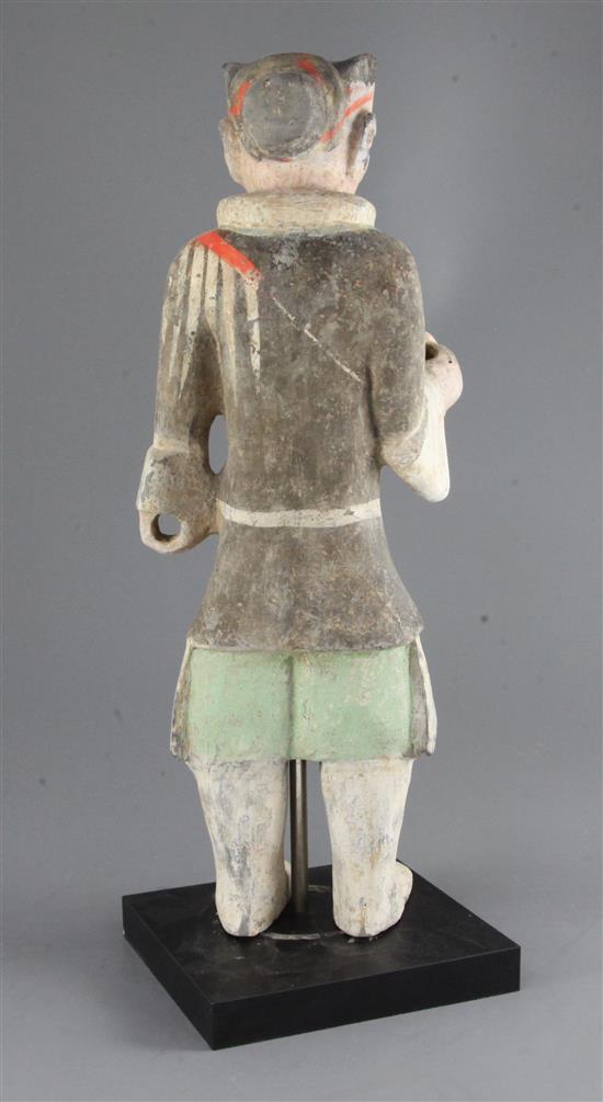 A large Chinese polychrome painted standing figure of a warrior, from Xian, Han dynasty (206BC-220AD), height 48cm, modern stand